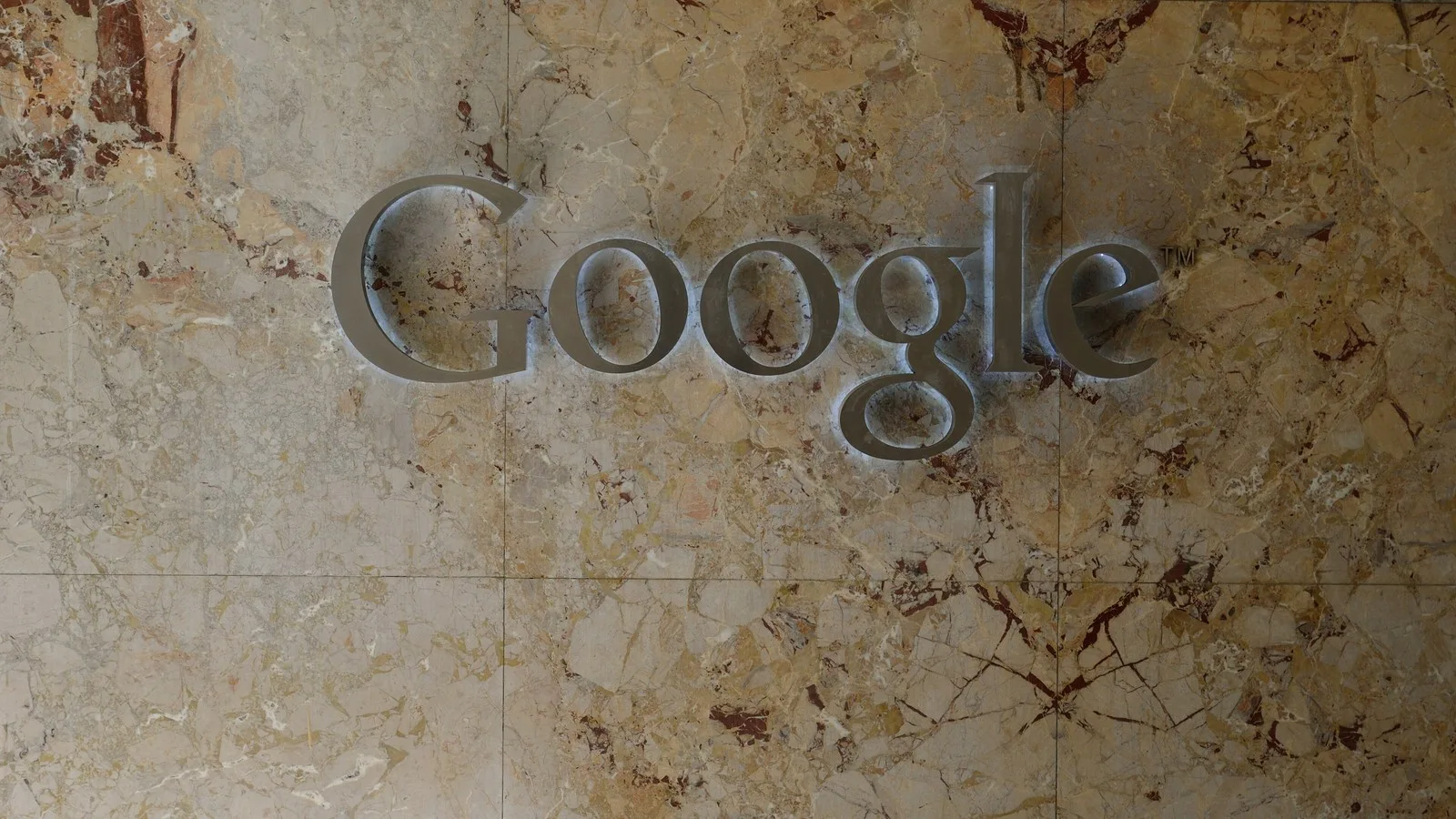 The Google sign on a marble wall at Google's Toronto office