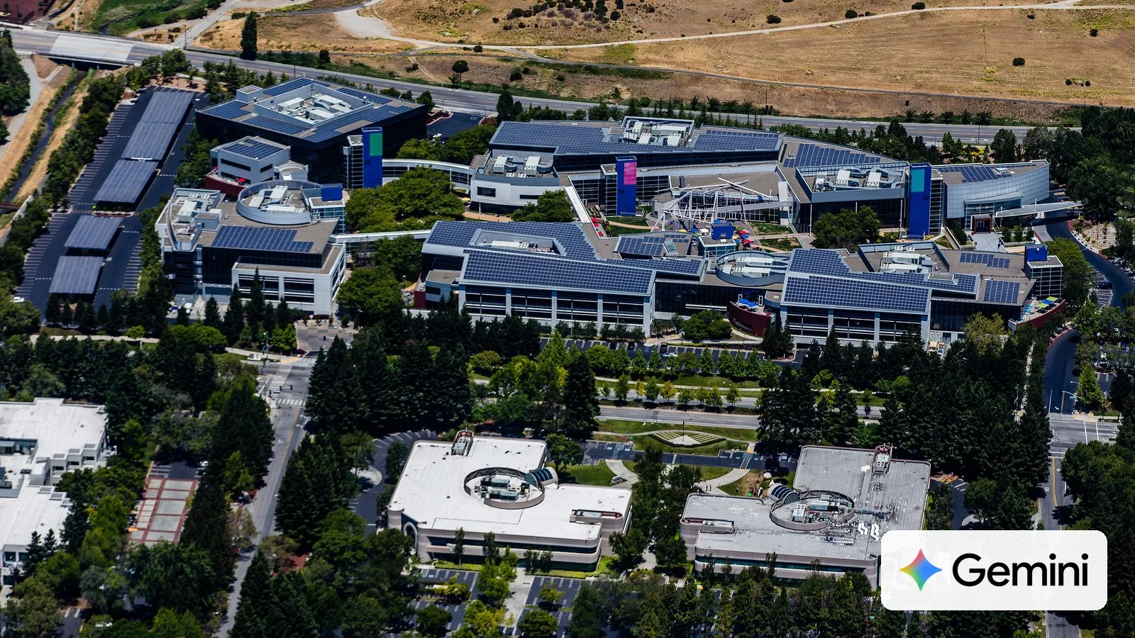 Aerial view of Google's main campus in Mountain View, California, with the Gemini logo