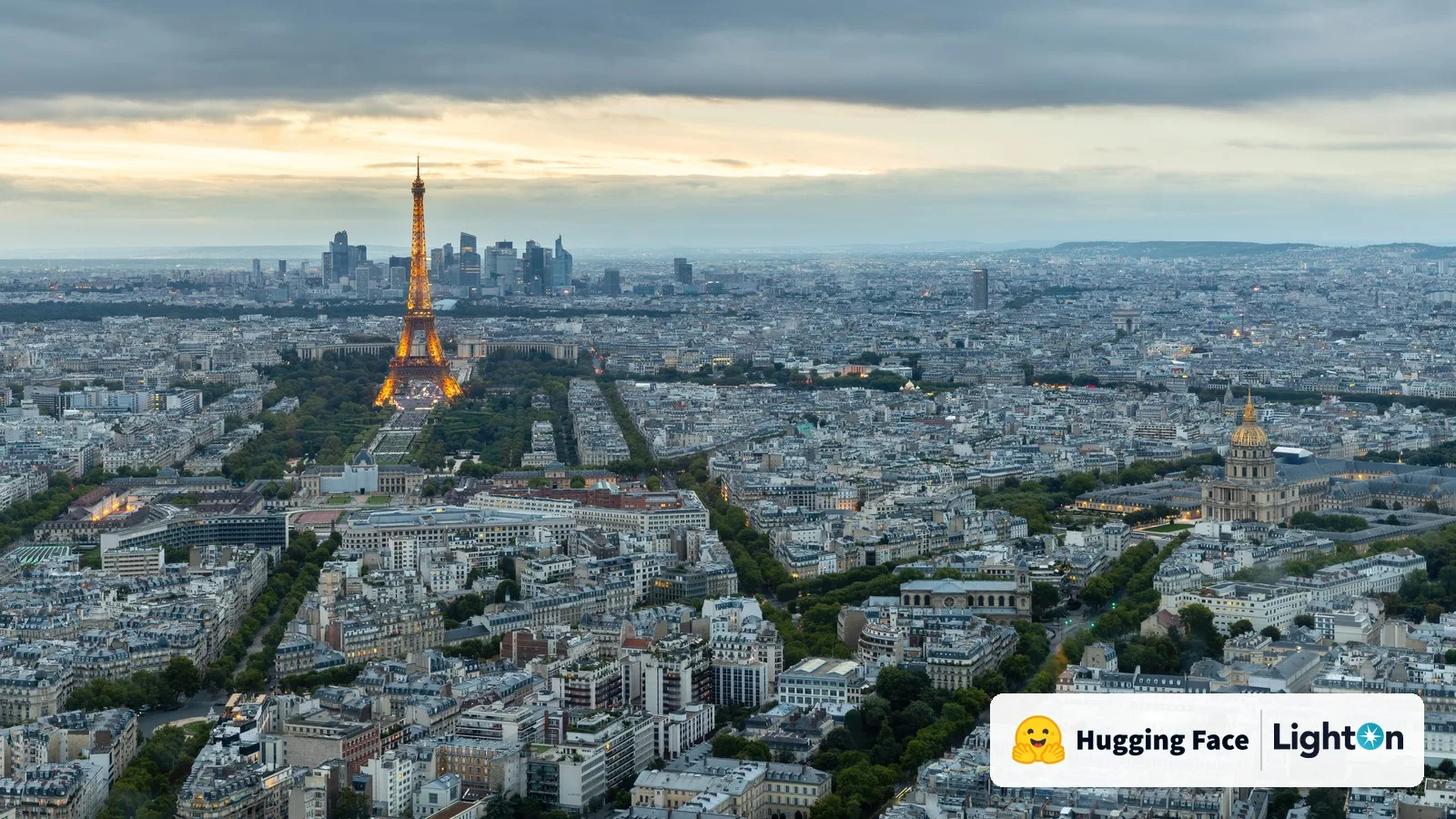 The Paris skyline at dusk with the Eiffel Tower, with the Hugging Face and LightOn logos