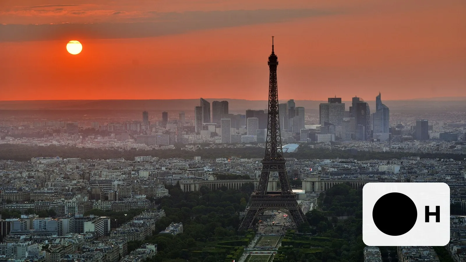 The Paris skyline at sunset, with the H Company logo
