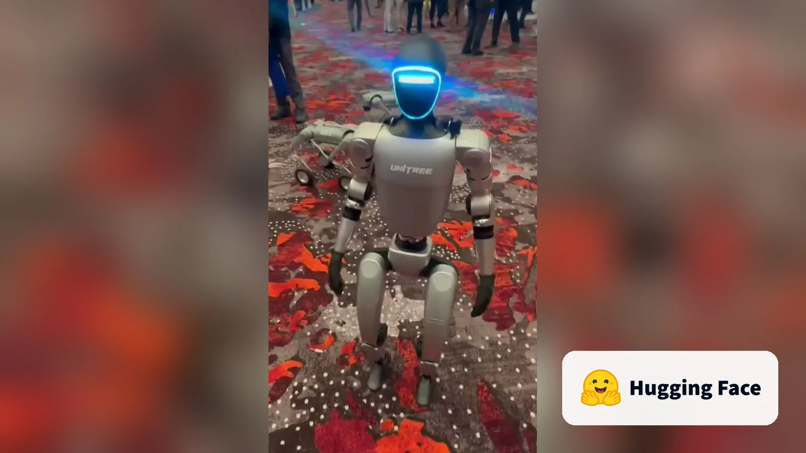 A Unitree G1 humanoid robot, with the Hugging Face logo