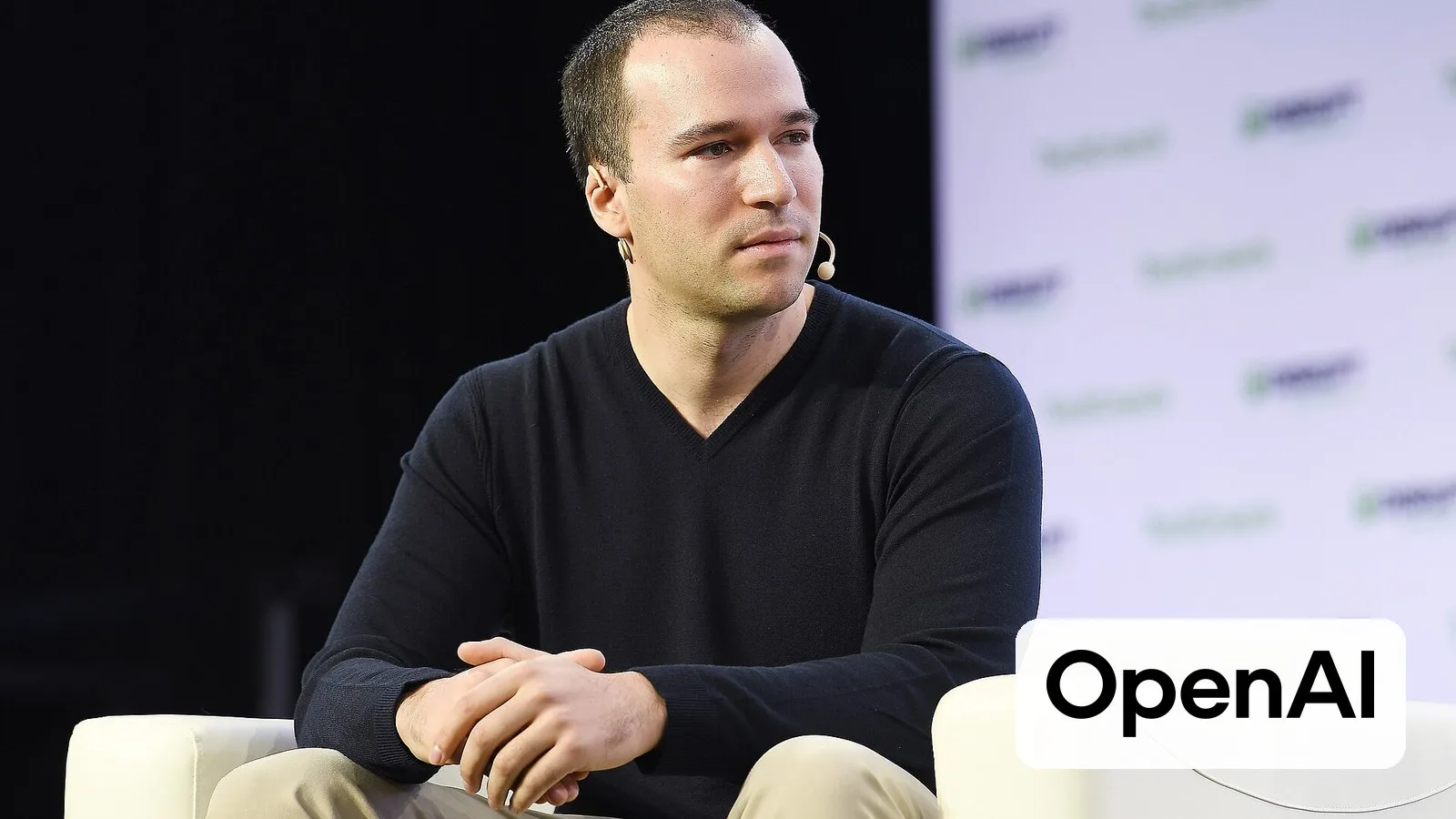 OpenAI president Greg Brockman, with the OpenAI logo