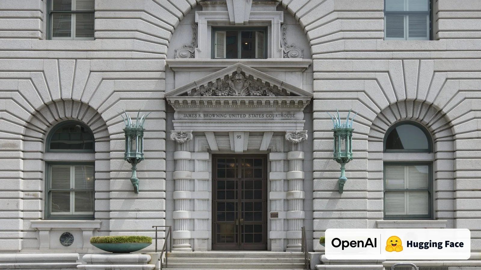 The entrance of the James R. Browning U.S. Courthouse, home of the Ninth Circuit Court of Appeals in San Francisco, with the OpenAI and Hugging Face logos