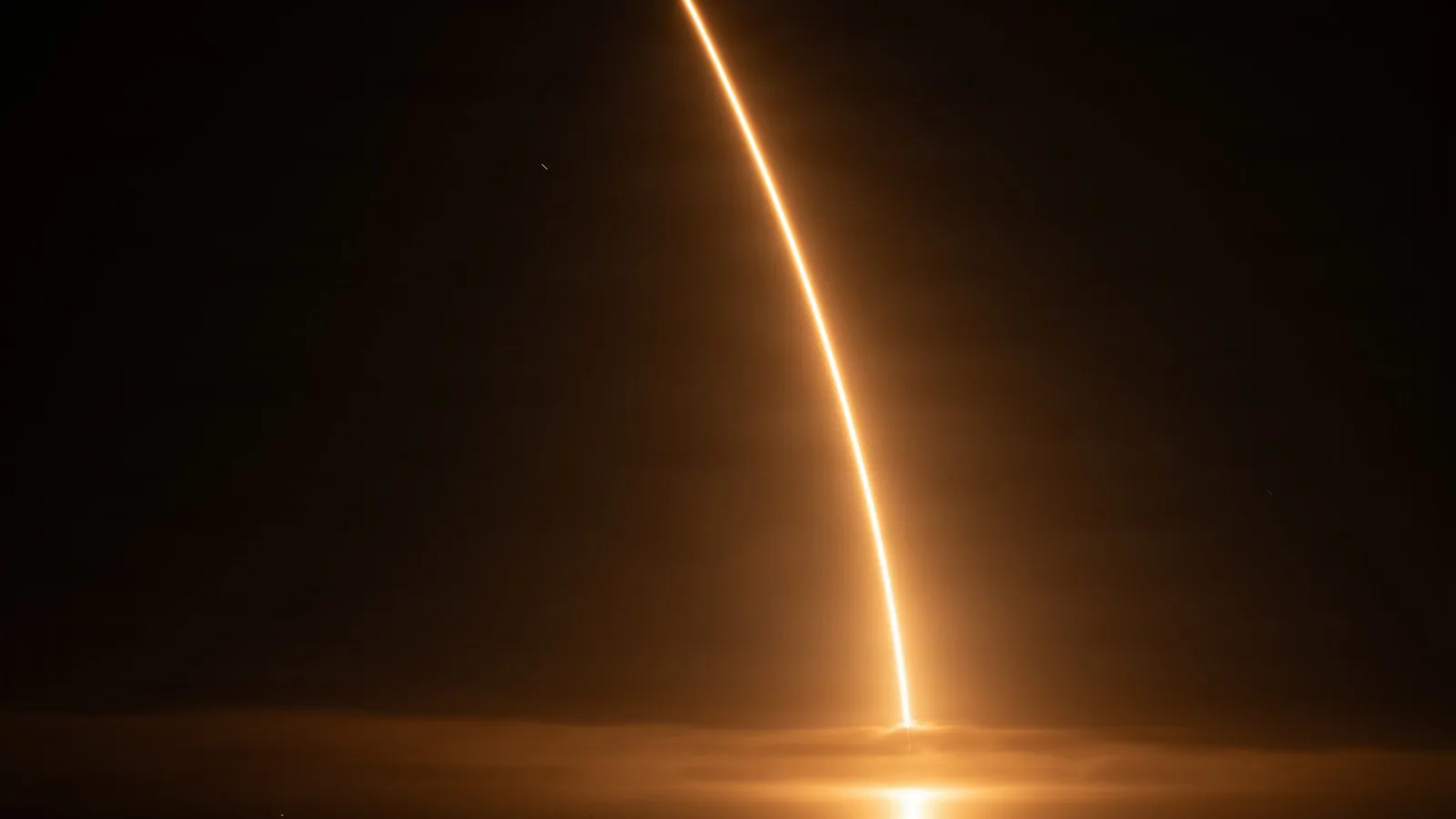 Long-exposure streak of a Falcon 9 rocket launching a Starlink mission from Vandenberg Space Force Base at night (file photo)